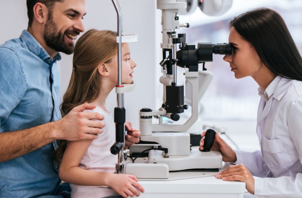A child and their father at an optometrist appointment.